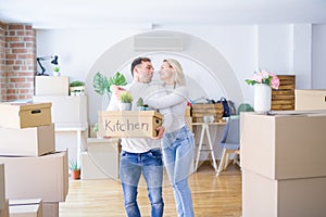 Young beautiful couple moving cardboard boxes at new home