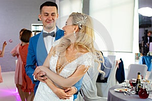 Young beautiful couple of newlyweds bride and groom during a wedding party dance. Love and lovestory of wife and husband before