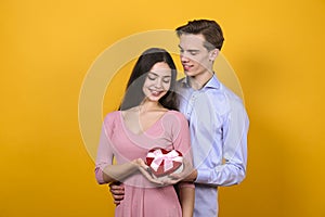 Young beautiful couple posing in studio.