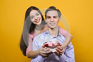 Young beautiful couple posing in studio.