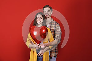 Young beautiful couple posing in studio.