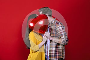 Young beautiful couple posing in studio.