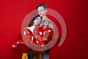 Young beautiful couple posing in studio.