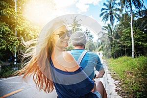 Young beautiful couple rides the jungle on a scooter, travel, fr