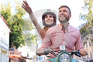 Young beautiful couple riding on motorbike. Adventure and vacations concept