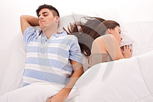 Young beautiful couple sleeping together in bed