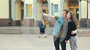 Young beautiful couple taking selfie outdoor in the city.