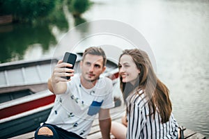 Young beautiful couple taking selfie on picnic