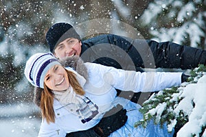 Young beautiful couple in winter park.