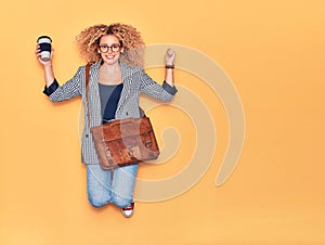 Young beautiful curly businesswoman wearing leather bag smiling happy