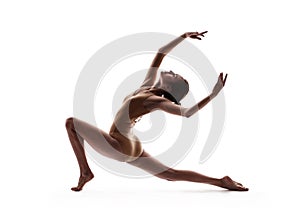 Young beautiful dancer in beige swimsuit