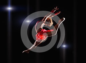 Young beautiful dancer gymnastics jumping in studio