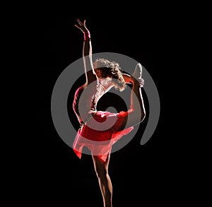 Young beautiful dancer gymnastics jumping in studio