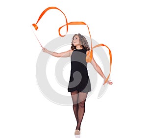 Young beautiful dancer gymnastics posing in studio with color ribbon