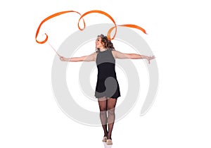 Young beautiful dancer gymnastics posing in studio with color ribbon