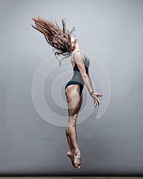 Young beautiful dancer posing in studio