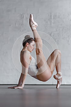Young beautiful dancer posing in studio