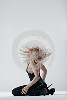 Young beautiful dancer is posing in studio