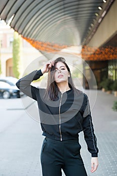 Young beautiful dark-haired woman in windy weather