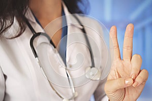 Young beautiful doctor woman using stethoscope over hospital hall background