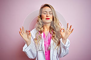 Young beautiful doctor woman using stethoscope over pink isolated background relax and smiling with eyes closed doing meditation