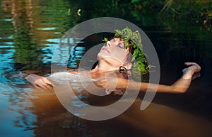 Young beautiful drowned woman lying in the water