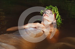 Young beautiful drowned woman lying in the water