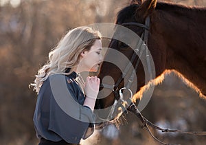 Young beautiful elegance modern woman posing with horse