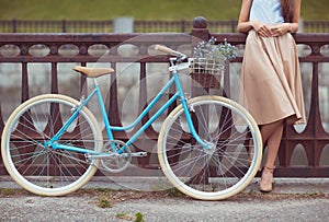 Young beautiful, elegantly dressed woman with bicycle