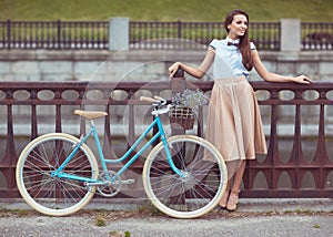 Young beautiful, elegantly dressed woman with bicycle