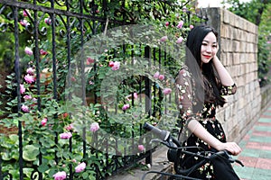 Young beautiful, elegantly dressed woman with bicycle. Healthy, cycling