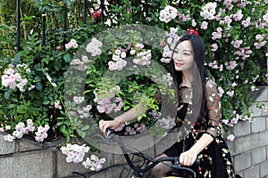 Young beautiful, elegantly dressed woman with bicycle. Healthy, cycling