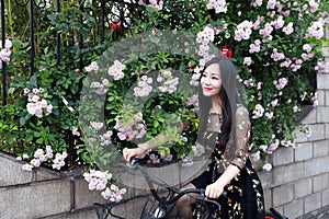 Young beautiful, elegantly dressed woman with bicycle. Healthy, cycling