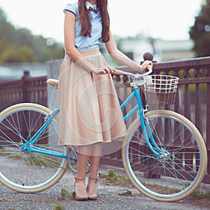 Young beautiful, elegantly dressed woman with bicycle. Beauty, f