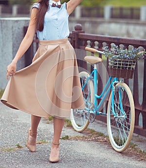 Young beautiful, elegantly dressed woman with bicycle. Beauty, f