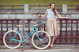 Young beautiful, elegantly dressed woman with bicycle