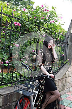 Young beautiful, elegantly dressed woman with bicycle. Healthy, cycling