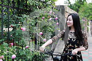 Young beautiful, elegantly dressed woman with bicycle. Healthy, cycling