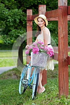 Young beautiful, elegantly dressed woman with retro bicycle. Healthy, cycling.