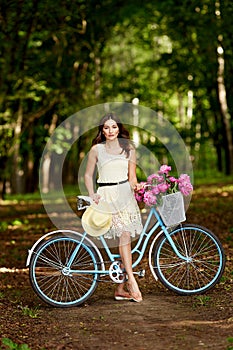 Young beautiful, elegantly dressed woman with retro bicycle. Healthy, cycling.