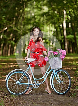 Young beautiful, elegantly dressed woman with retro bicycle. Healthy, cycling.