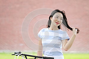 Young beautiful, elegantly dressed woman with Sharing bicycle. Beauty, fashion and lifestyle