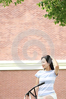 Young beautiful, elegantly dressed woman with Sharing bicycle. Beauty, fashion and lifestyle