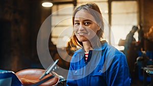 Young Beautiful Empowering Woman Gently Smiles at the Camera. Authentic Fabricator Wearing Work Cl photo