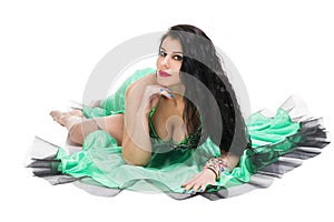 Young beautiful exotic eastern women in ethnic green dress. Isolated on white background