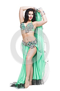 Young beautiful exotic eastern women performs belly dance in ethnic green dress. Isolated on white background