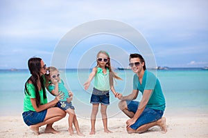 Young beautiful family of four enjoyed relaxing on