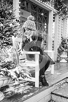 Young beautiful fashion girl is enjoying her time through winter holiday in Christmas evening, Moscow, Tverskaya Square