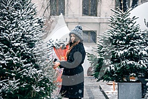 Young beautiful fashion girl is enjoying her time through winter holiday in Christmas evening, Moscow, Tverskaya Square