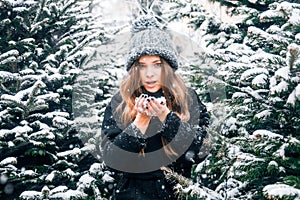 Young beautiful fashion girl is enjoying her time through winter holiday in Christmas evening, Moscow, Tverskaya Square